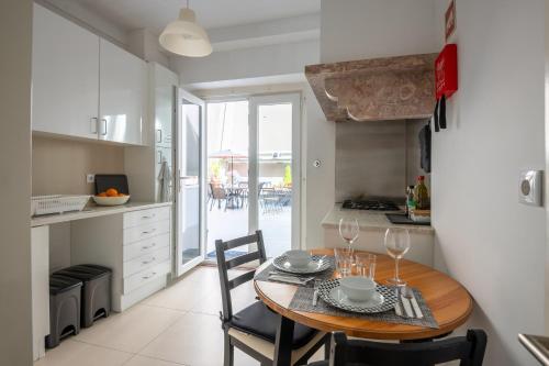 a kitchen and dining room with a table and chairs at DuMont Lisbon Guesthouse in Lisbon
