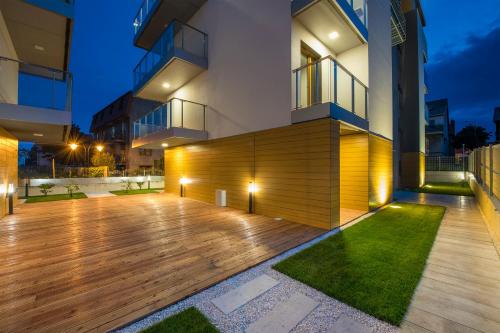 a house with a wooden deck in front of it at Baltic Sands in Hel