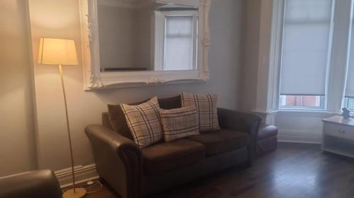 a living room with a chair and a mirror at Coastal stay in South Shields
