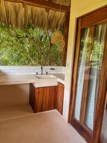 a bathroom with a sink and a large window at Villas Indigo Troncones in Troncones