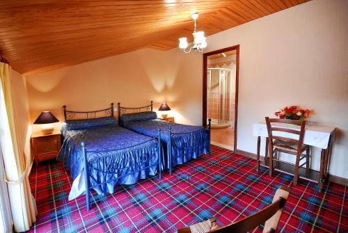 a bedroom with a bed and a table in a room at Domaine de la Chambre in Verrières
