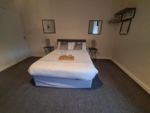 a bedroom with a large bed with a tray on it at The Green in Sunderland