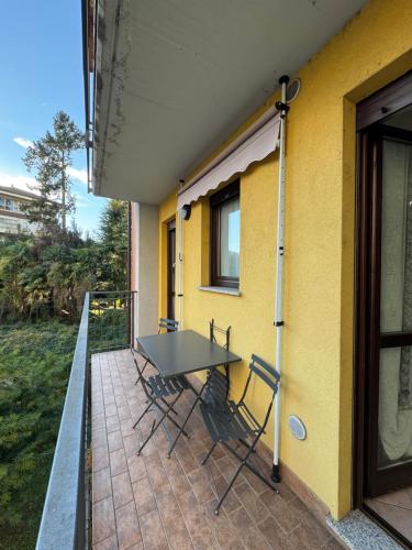 a patio with a table and chairs next to a building at Appartamento Amendola in Luino