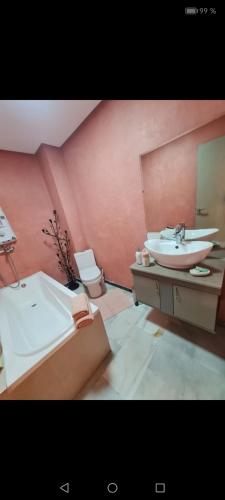 a bathroom with a sink and a tub and a toilet at guiliz in Marrakech