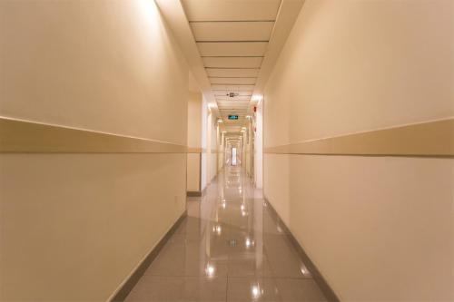 a long corridor in a building with empty shelves at Jinjiang Inn Anyang Railway Station in Anyang
