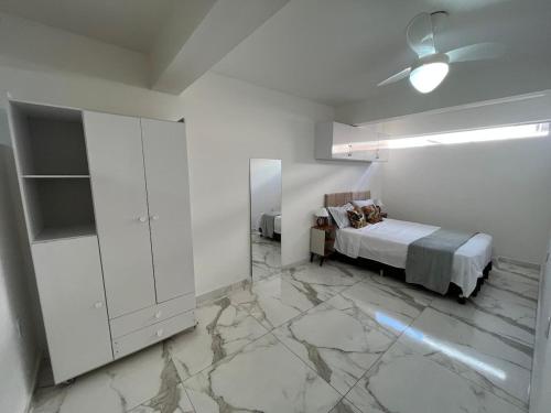 een slaapkamer met een bed en een grote marmeren vloer bij Recanto do Vale in Diamantina