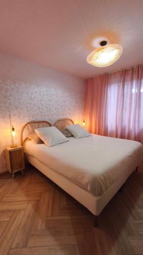 a bedroom with a large bed with two pillows at L Atelier du zoo in Sablons