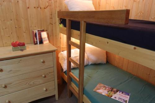 a bedroom with two bunk beds and a desk at Cimes De Caron Appartements VTI in Val Thorens