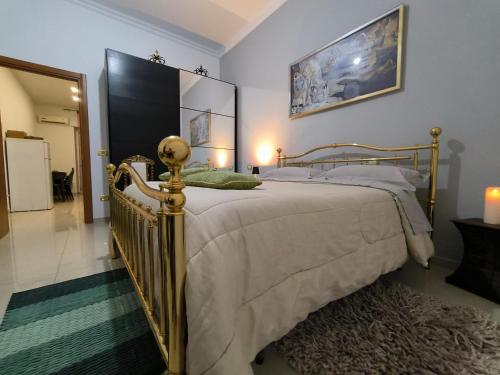 a bedroom with a bed with a gold frame at By Domy 2 Grottaglie in Grottaglie