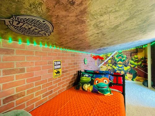 a room with a brick wall and a bed with a toy at Radical 80's Getaway! A Blast From The Past! in Sandusky