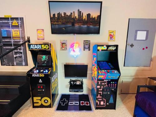 a room with two arcade games and a tv at Radical 80's Getaway! A Blast From The Past! in Sandusky