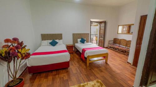 Postel nebo postele na pokoji v ubytování Casona MICA'S HOUSE