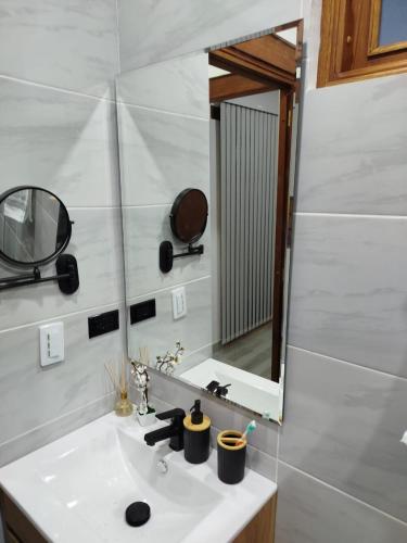 a bathroom with a sink and a mirror at Cabaña in Sáchica