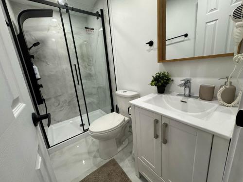a bathroom with a shower and a toilet and a sink at Cute & Cozy Hub for Montreal Travelers in Montréal