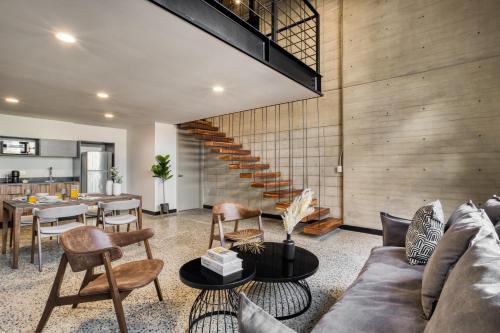 a living room with a couch and a table at Downtown Loft by ULIV in Tijuana