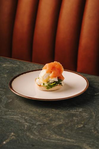 a sandwich on a plate on a table at The Cyrus Hotel in Wrocław