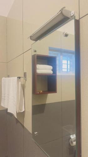 a bathroom with a mirror and some towels at TAMARA VISTA Executive Homestay in Varkala