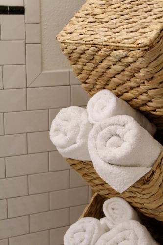 a stack of towels in a basket in a bathroom at Fundy Footprints in Saint Martins