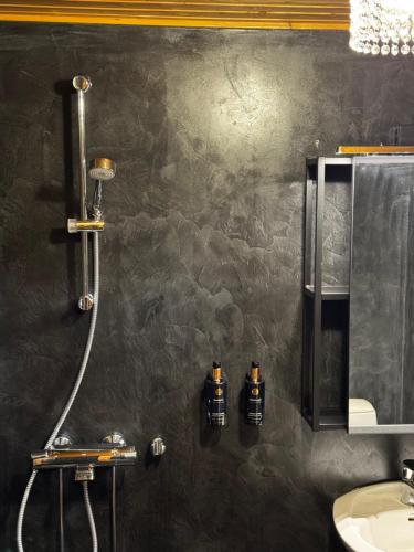 a bathroom with a shower and a sink at Hotel & Resort Sallavalkea in Salla