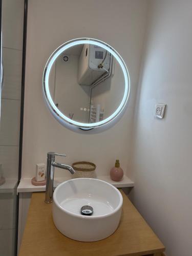 a bathroom with a white sink and a mirror at Cozy T2 - L'Herbaudière - 200m de la plage in Noirmoutier-en-l'lle