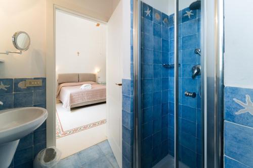 a bathroom with a shower and a sink at Villa Maresole in Favignana