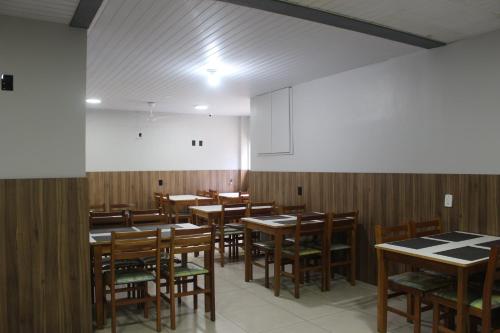 バウネアーリオ・コンボリウーにあるHotel Di Sicaの木製のテーブルと椅子のあるダイニングルーム