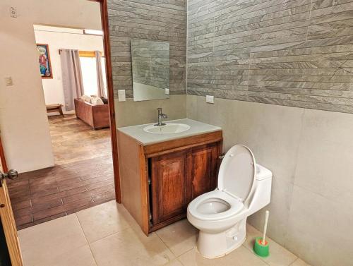 a bathroom with a toilet and a sink at Villa Piedra Viva in Tilarán