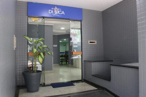 an elevator in a building with a potted plant at Hotel Di Sica in Balneário Camboriú