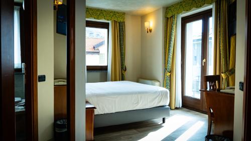 Postel nebo postele na pokoji v ubytování Hotel Au Soleil