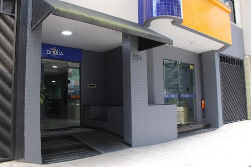 a front door of a store with the door open at Hotel Di Sica in Balneário Camboriú