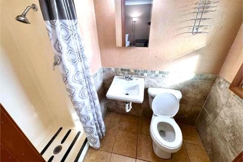 a small bathroom with a toilet and a sink at Skylark Motel by OYO in Bedford