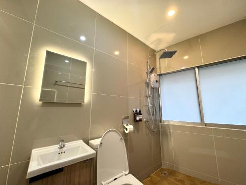a bathroom with a toilet and a sink at Sonata siam-ratchathewi in Bangkok