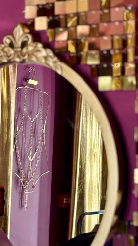 a reflection of a necklace in a mirror at Designer Fantasy Den Boutique Seafront in Brighton & Hove
