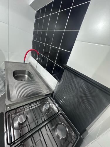 a small kitchen with a sink and a stove at Container Porto Alvorada in Imbituba