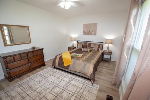 a bedroom with a bed with a dresser and a mirror at Charming Lafayette Condo Cozy Retreat in Indiana in Lafayette