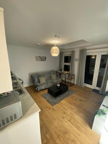 a living room with a couch and a table at Luxury home from home 2 in Maidstone