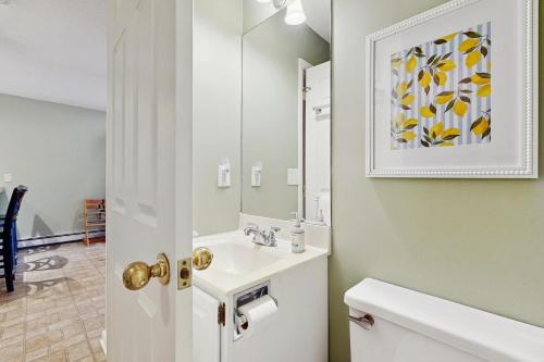 a bathroom with a sink and a mirror at Newton Village 2B in Quechee