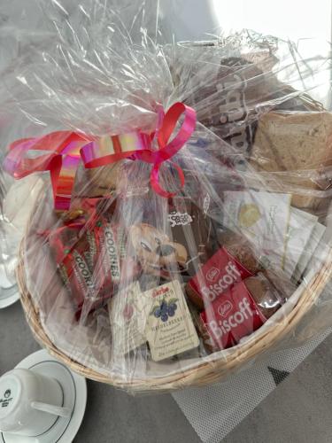 Airb&b Mery Milano-Cortina في ميلانو: سلة مليئة بأنواع مختلفة من البسكويت والحلوى