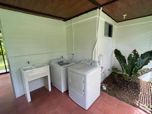 a bathroom with two washing machines and a sink at Serene Oasis Hideaway in Fortuna