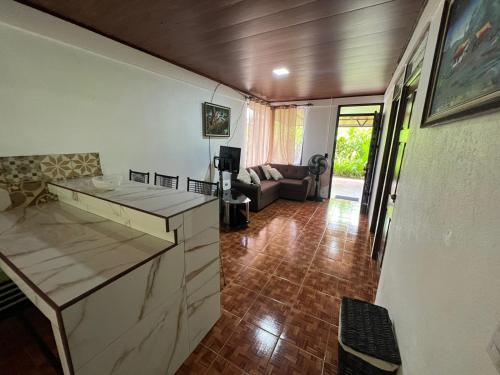 a kitchen and living room with a counter and a couch at Serene Oasis Hideaway in Fortuna