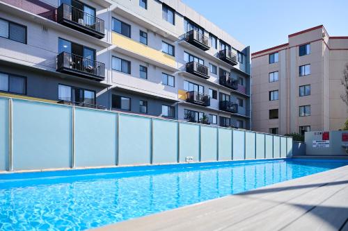 a swimming pool in front of a building at Central Perth Apartment with Pool in Perth
