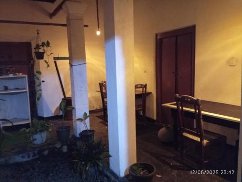 a living room with a table and chairs in a room at Grandma's House Villa in Weligama
