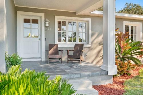 a patio with a table and chairs on a house at Marsh Front Birders Paradise Close to Beaches and Downtown in St. Augustine