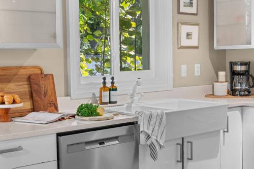 a white kitchen with a sink and a window at Marsh Front Birders Paradise Close to Beaches and Downtown in St. Augustine