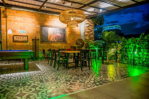 a restaurant with tables and chairs and a pool table at hotel civitas medellin in Medellín