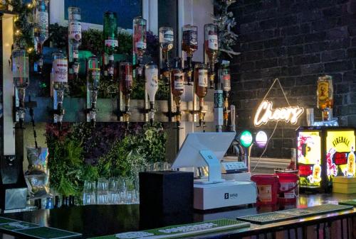 a bar with a bunch of wine bottles hanging from a wall at The Dame Lane in Blackpool