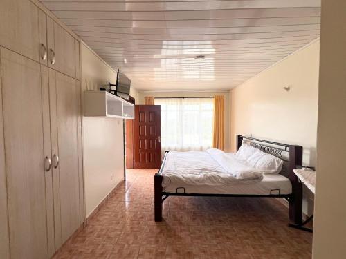 a bedroom with a bed in a room at Cleo luxe villa in Makandara