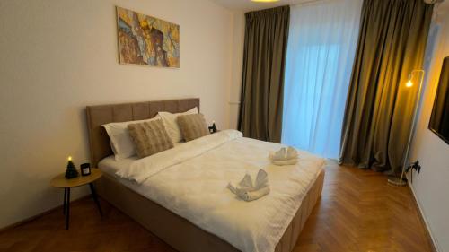 a bedroom with a bed with two candles on it at Ultracentral 13 in Craiova