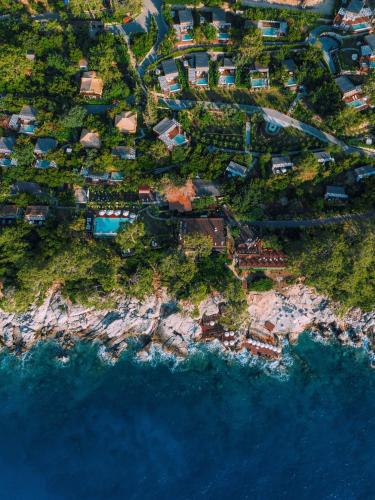 an aerial view of a village on the edge of the ocean at Lov Faralya Adults Only in Faralya
