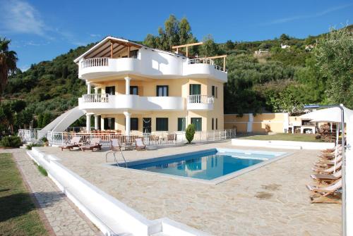 a villa with a swimming pool and a house at Villa Alex in Riza
